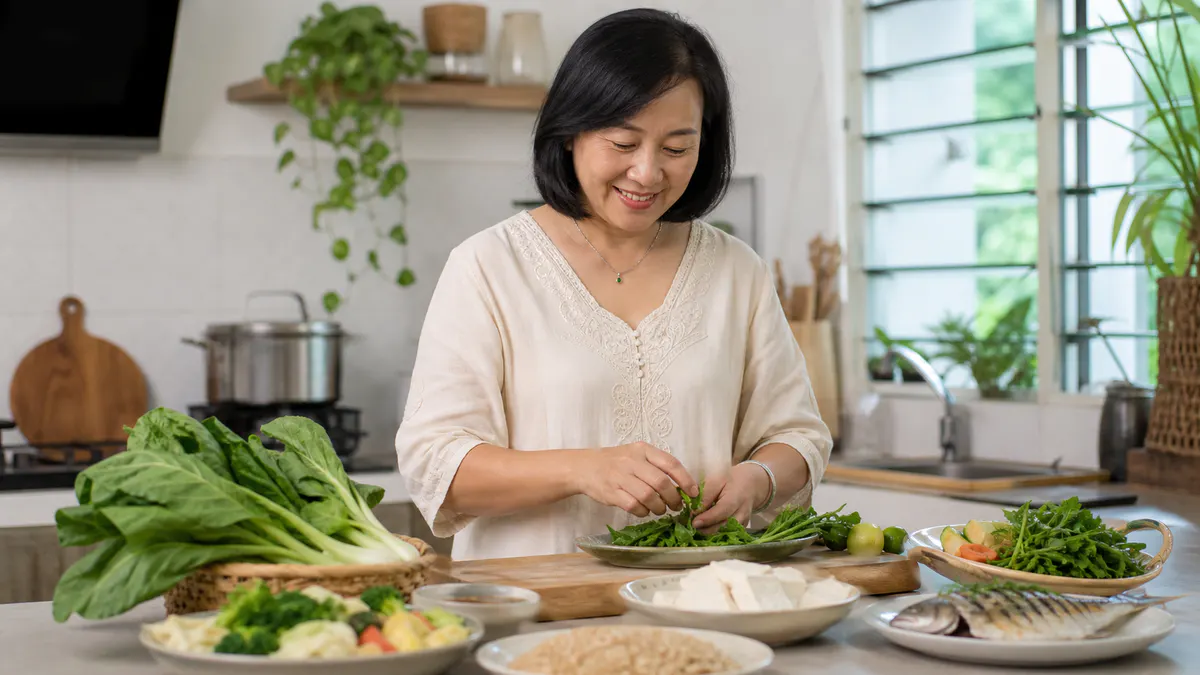 Malaysian Chinese woman preparing a balanced Malaysian meal.